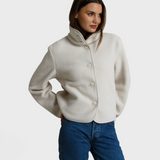 Model wearing a JONES + CO sugar white sherpa button-front jacket with a high collar and long sleeves.