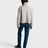Model wearing a JONES + CO Tara sugar white sherpa button front jacket with a high collar, viewed from the back.