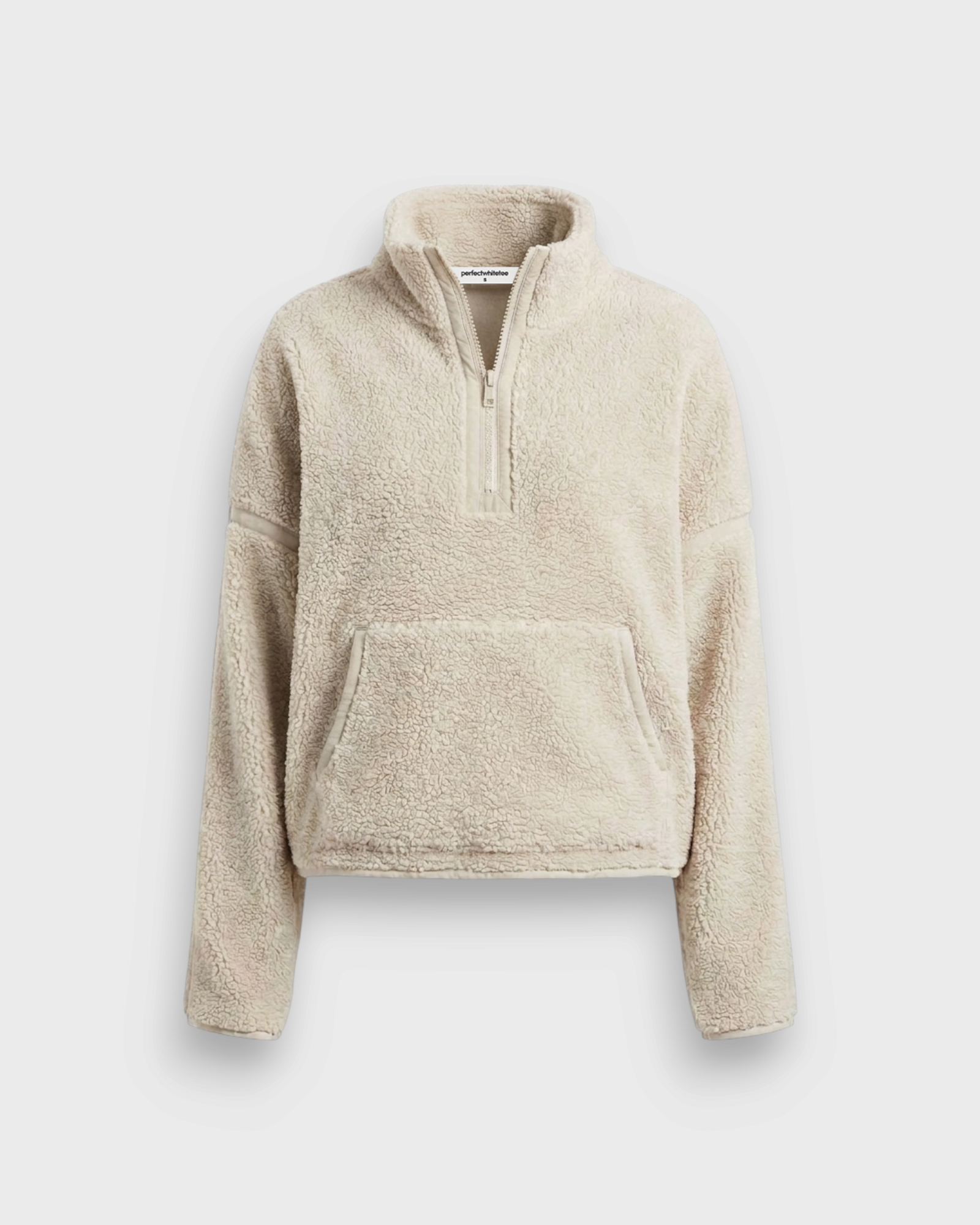 JONES + CO Tristan sherpa half-zip pullover in sugar cream with a front kangaroo pocket and high collar.