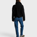 JONES + CO Tristan black sherpa half-zip pullover worn by a model from the back against a neutral backdrop