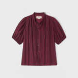 JONES + CO Mira blouse in garnet shadow-stripe with ruffled stand collar, pintucked bib, and short puffed sleeves.