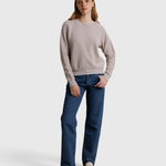 Model wearing a JONES + CO cloud gray textured crewneck sweatshirt with blue jeans and loafers