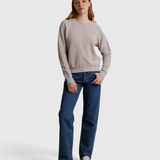 Model wearing a JONES + CO cloud gray textured crewneck sweatshirt with blue jeans and loafers