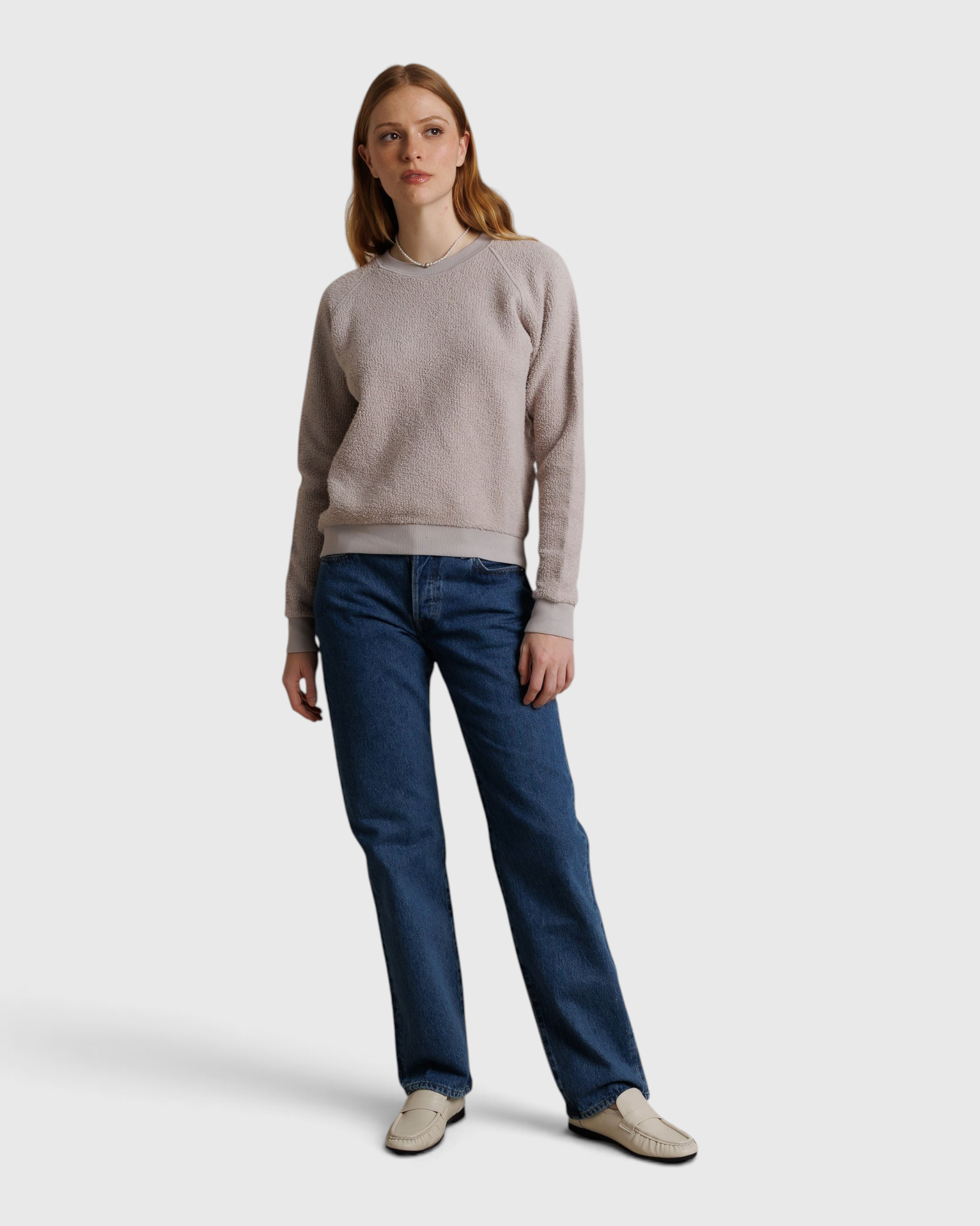 JONES + CO Ziggy sweatshirt in cloud gray fleece worn by a model with blue jeans and white loafers