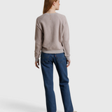 JONES + CO Ziggy sweatshirt in cloud gray with a textured fleece finish, worn by a woman with blue jeans