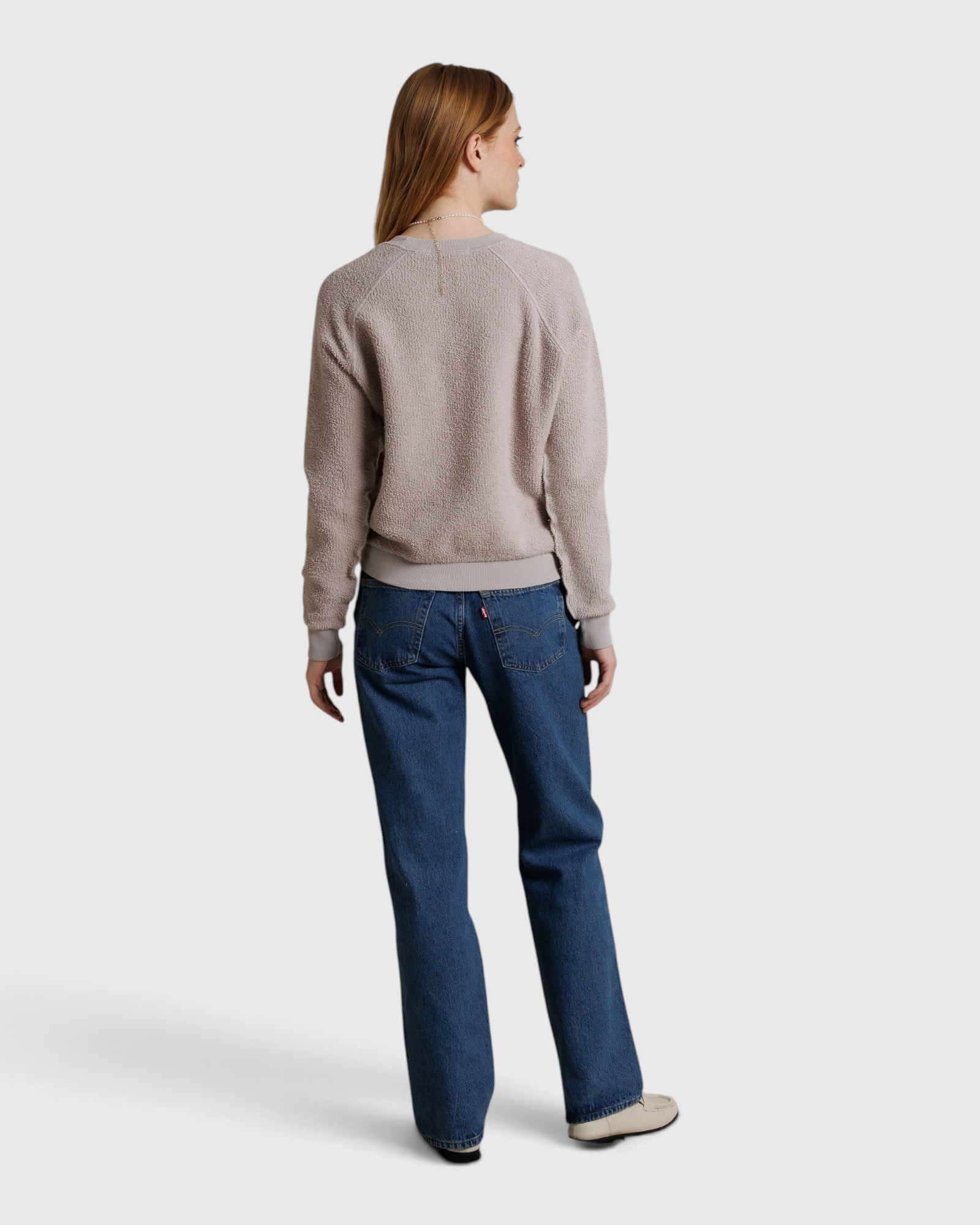 JONES + CO Ziggy sweatshirt in cloud gray with a textured fleece finish, worn by a woman with blue jeans
