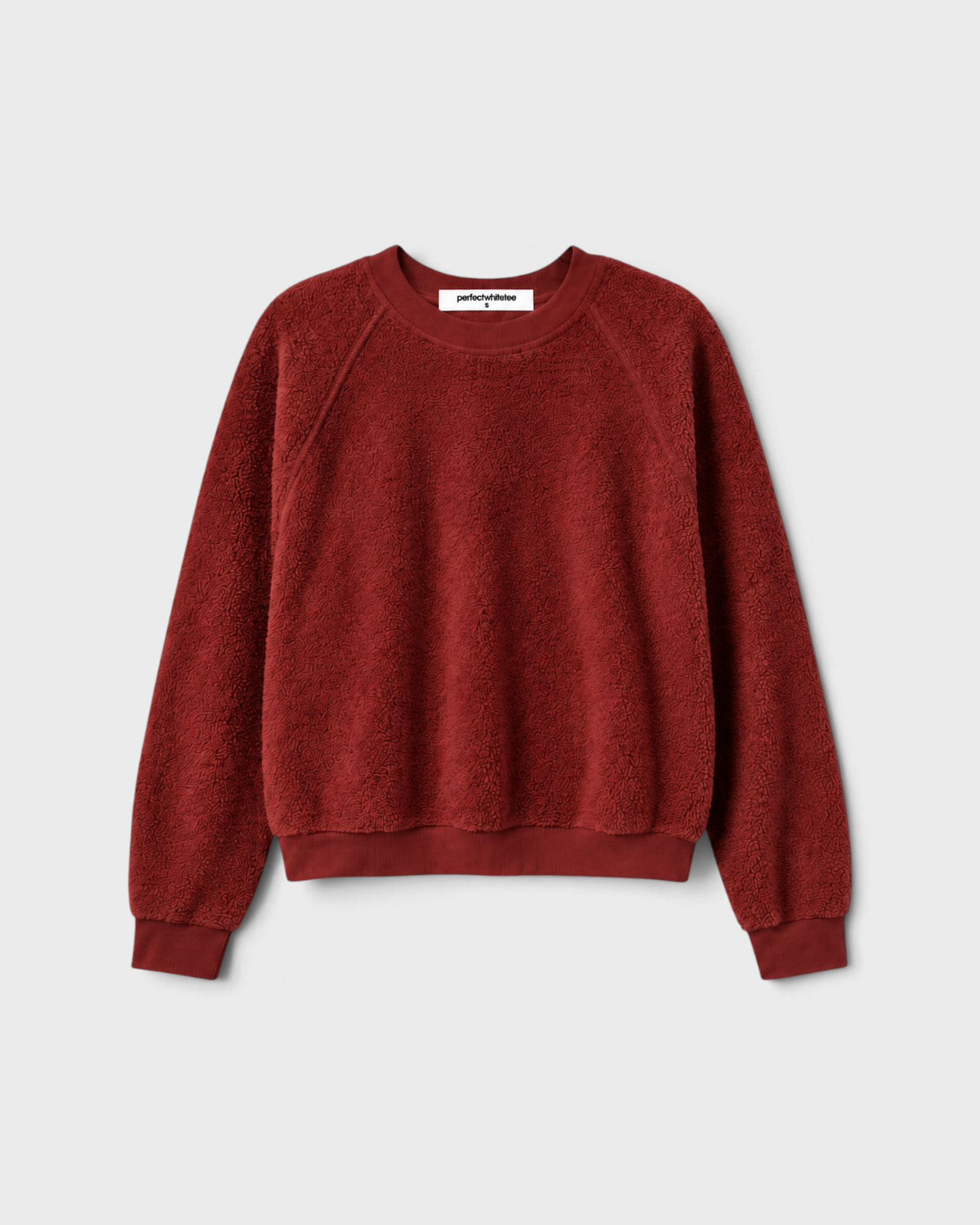JONES + CO Ziggy sweatshirt in ruby red featuring a shrunken crewneck and textured inside-out fleece fabric.