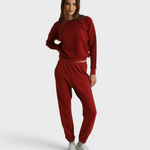 Model wearing JONES + CO ruby red Ziggy sweatshirt with shrunken crewneck and matching fleece joggers