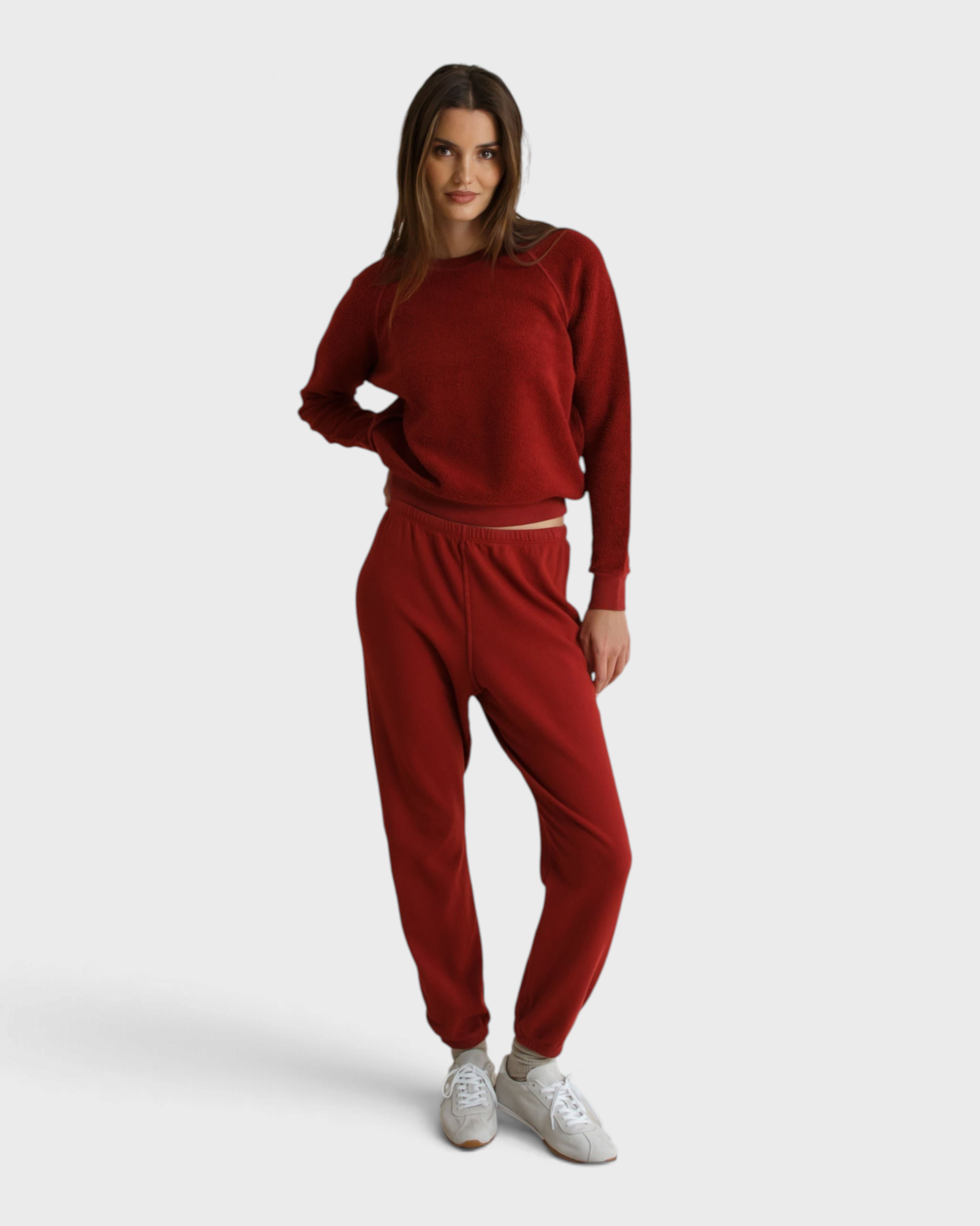 Model wearing JONES + CO ruby red Ziggy sweatshirt with shrunken crewneck and matching fleece joggers